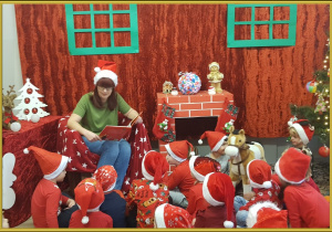 Pani Mirka czyta dzieciom bajkę o Mikołaju.